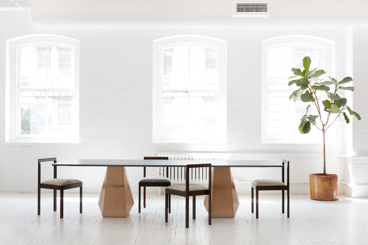 table and four chairs in white room