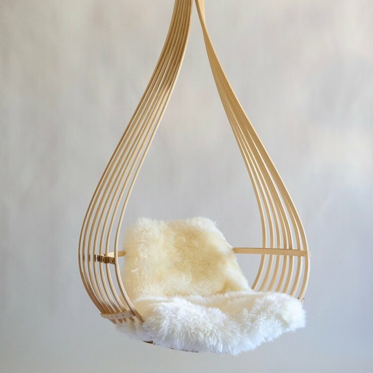 hanging chair with white cushion