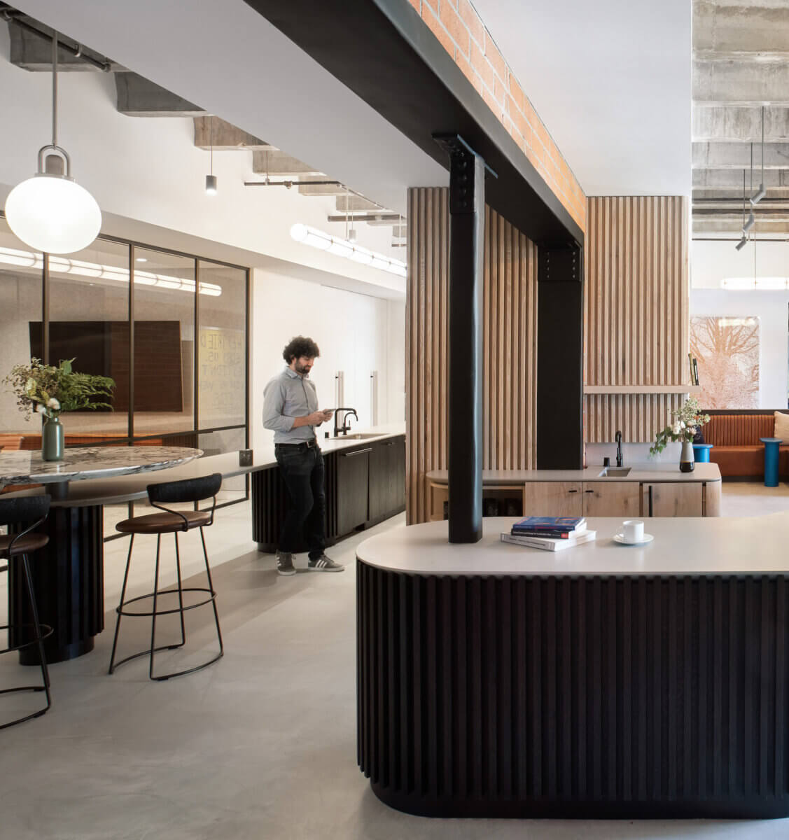 A structural wall supports the core communal spaces of a modern office in San Francisco.