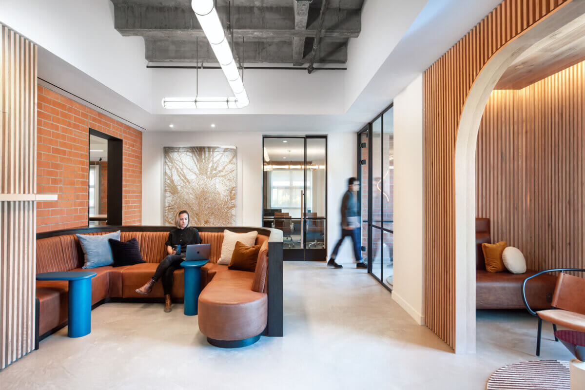 Custom leather and wood banquette in a lounge space in a modern office.