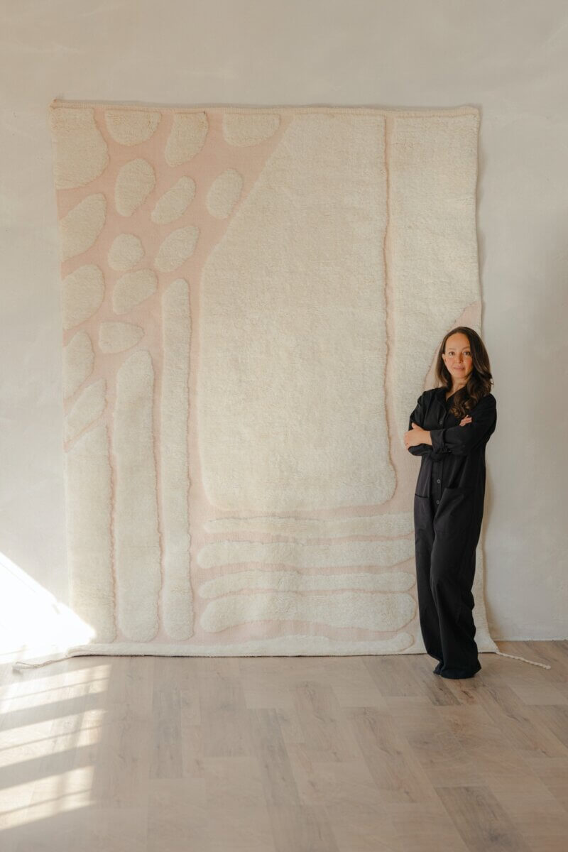Khalida Tóukkani pictured with one of Maison Tóukkani's rugs