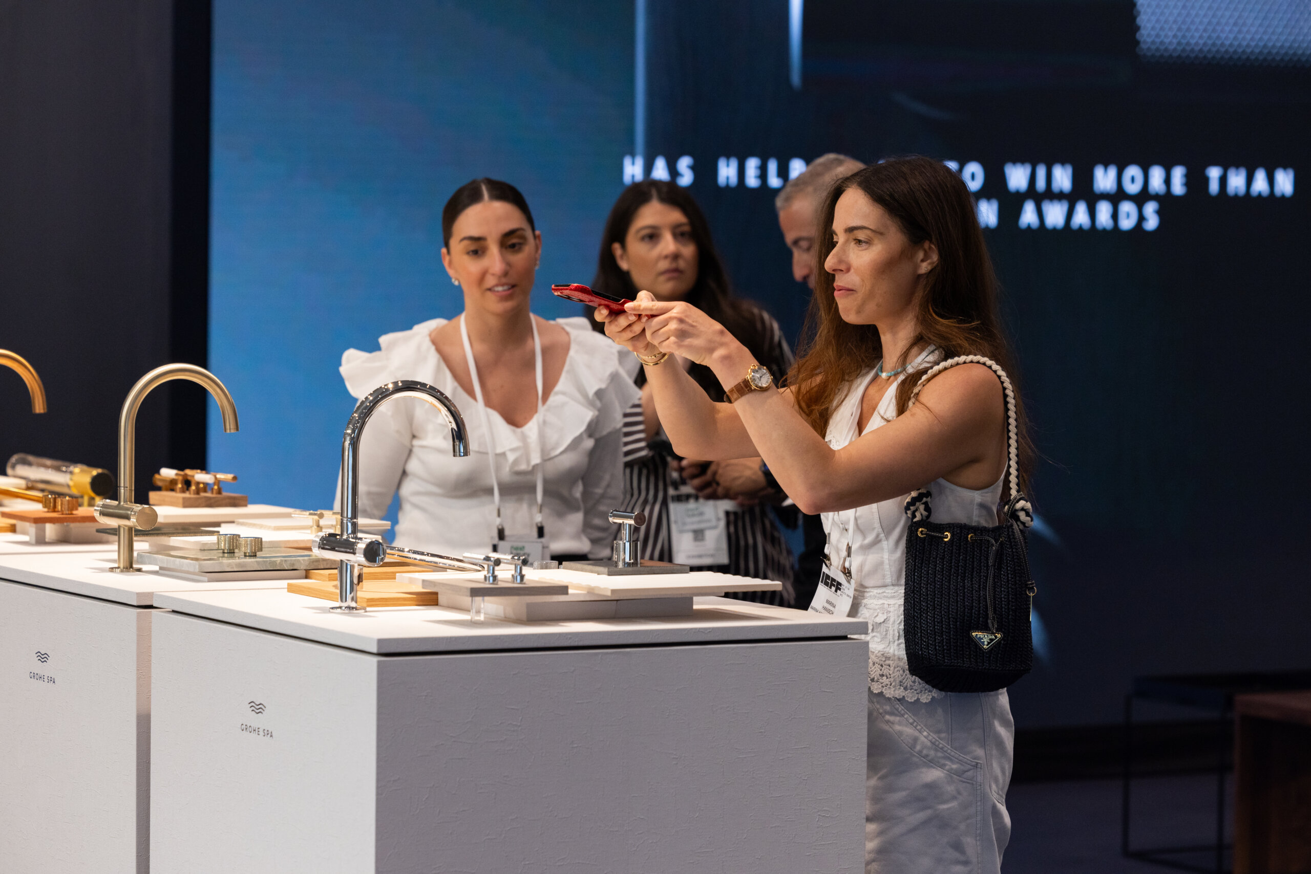 Woman taking a photo in the Aqua Atelier at ICFF 2026