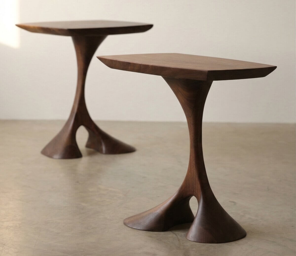 Wooden end table with two distinct legs, curved and smooth.